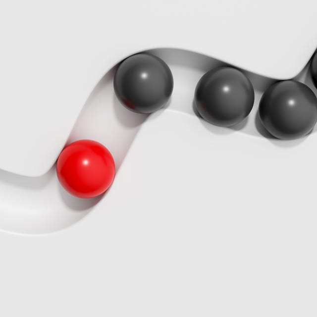 Abstract 3D conceptual background. Red sphere is separate from the black balls on white backdrop. Concept of leadership, confidence, aspirations, individuality, Standing Out From The Crowd. Abstract 3D conceptual background. Red sphere is separate from the black balls on white backdrop. Concept of leadership, confidence, aspirations, individuality, Standing Out From The Crowd.