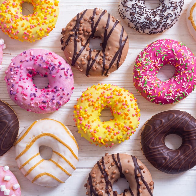 assorted donuts with chocolate frosted, pink glazed and sprinkles . top view
