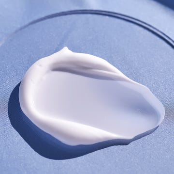 A smear of white cream on a blue silk background. a smear of white cream on a blue silk background.