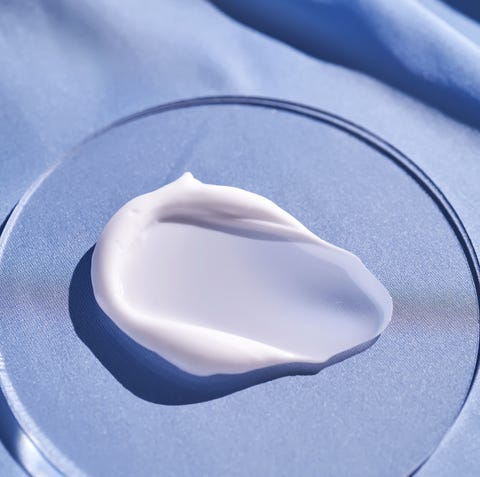 a smear of white cream on a blue silk background.
