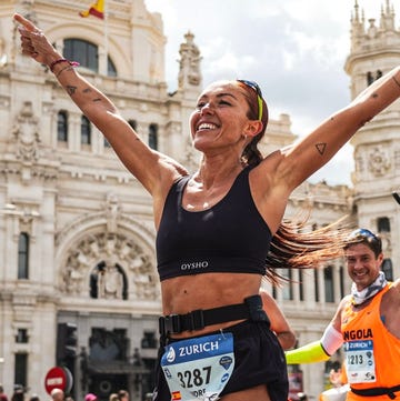 runner celebrating during a marathon with a significant building in the background