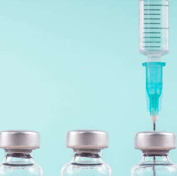 whooping cough vaccine vials of vaccine and a syringe on a blue background