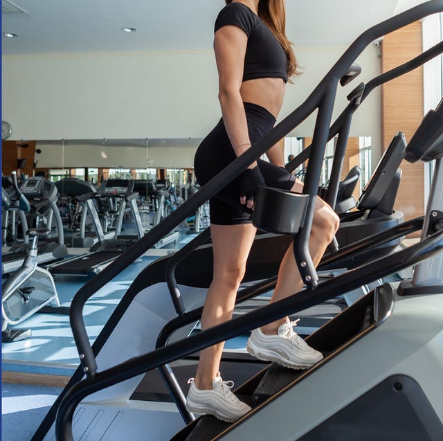 two individuals exercising on gym equipment