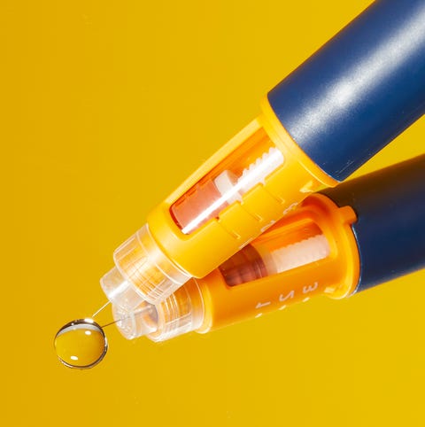 pen with a transparent tip and a water droplet on a reflective surface pen with a transparent tip and a water droplet on a reflective surface