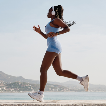 power walking vs jogging: one woman power walking outdoors and one woman jogging outdoors.