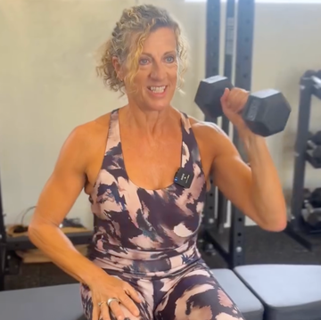 sally gunnell home workout: sally performing two dumbbell exercises