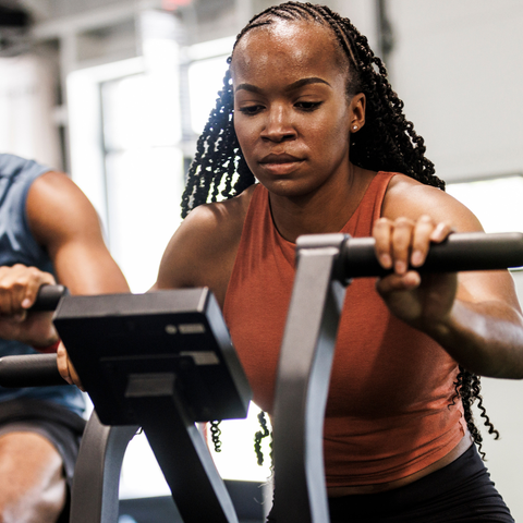 exercise vs nap: side by side of woman indoor cycling and waking up from nap