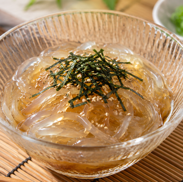 japanese tokoroten noodles topped with seaweed and sesame seeds.