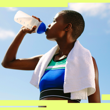 Athlete drinking from a sports bottle, wearing a towel around the neck, against a blue sky background. Athlete drinking from a sports bottle, wearing a towel around the neck, against a blue sky background.